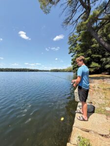 The waterfront near Lake Cochituate’s pump house provides easy access for fishing. (Photo by Ellie Brogan)