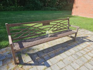 A bench with a plaque inscribed with a portion of a poem by Jane Louise Simpkin outside of the Arts Building at Wayland High School. (Courtesy photo)