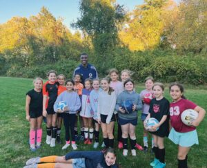 New England Revolution defender Mamadou Fofana recently spent time with a youth soccer team in Wayland, helping lead a training session and connecting with players.