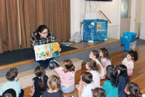 Haley Neil from the Wayland Public Library visited students at Community Nursery School of Wayland on Oct. 5. She read to the students and explained all the fun and interesting things to do when visiting the library. (Photo courtesy Community Nursery School)
